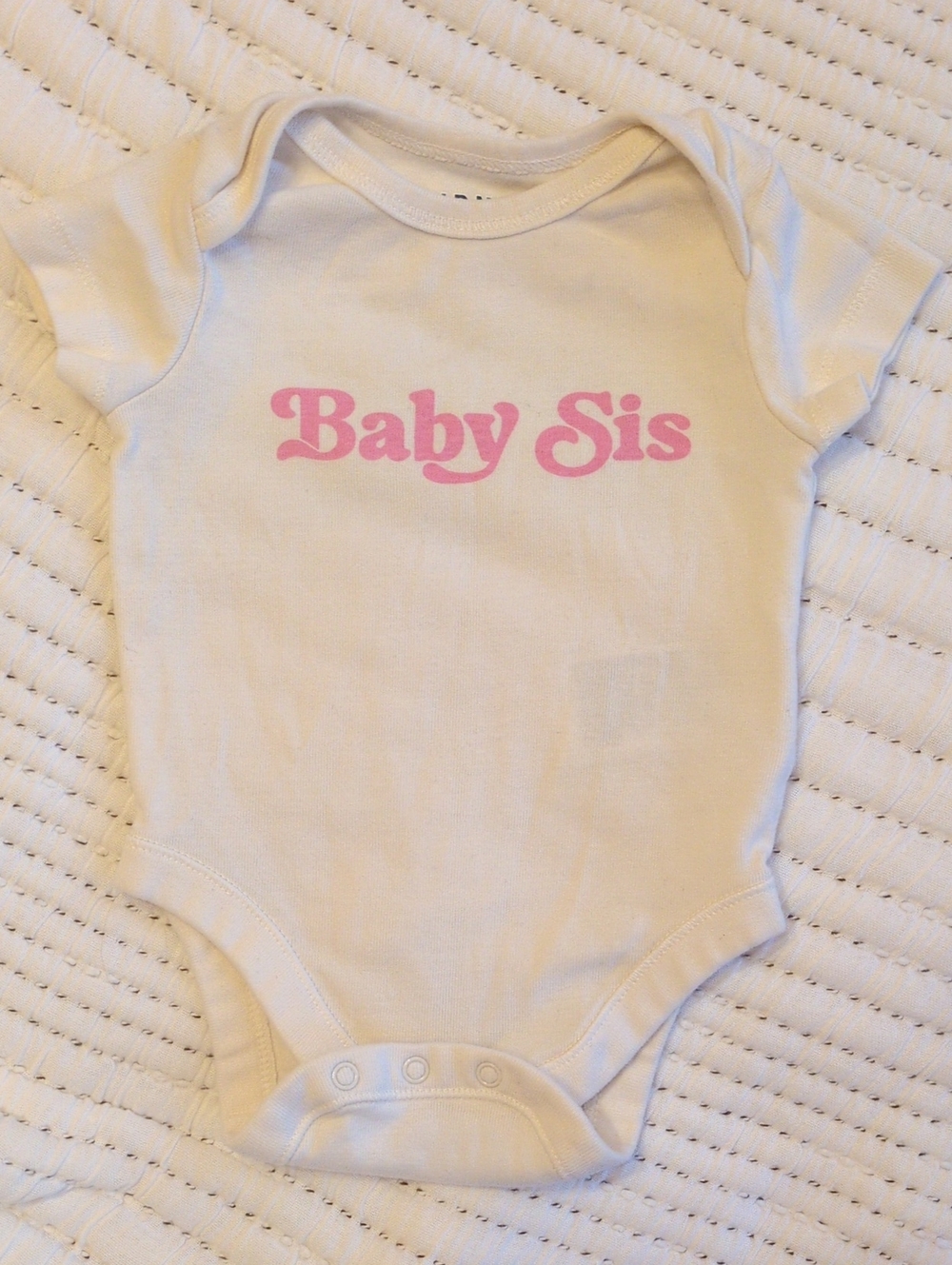 White "Baby Sis" One-Piece Bodysuit with Pink Script